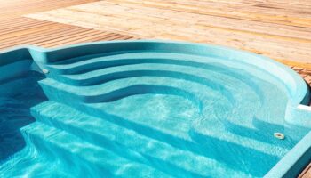 Modernes GFK Pool mit integrierten Treppenstufen und Holzdeck
